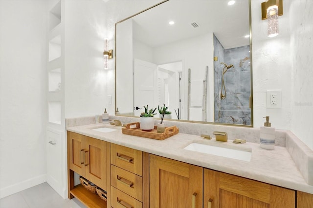 420 48th St N, Saint Petersburg, FL 33713 - full bathroom with double vanity, visible vents, a sink, and a walk in shower