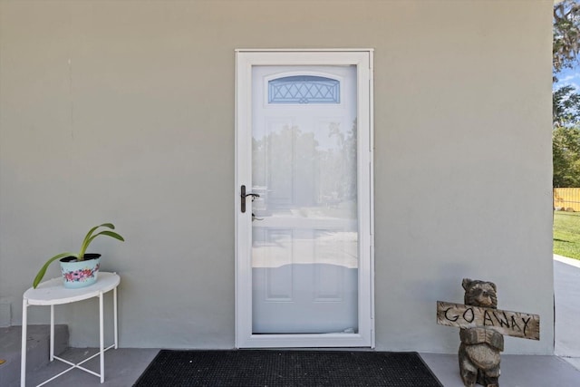 view of exterior entry featuring stucco siding