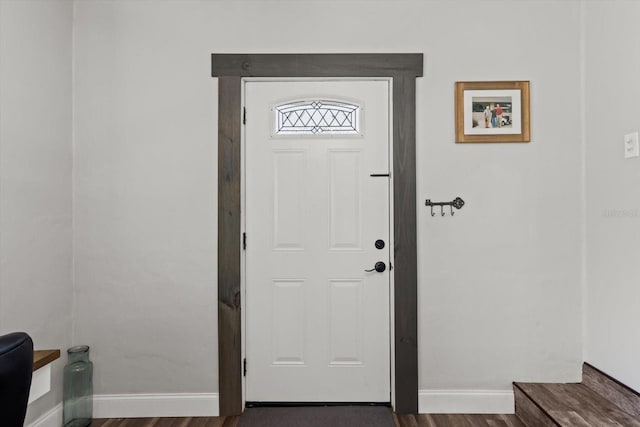 entryway with baseboards and dark wood-style flooring