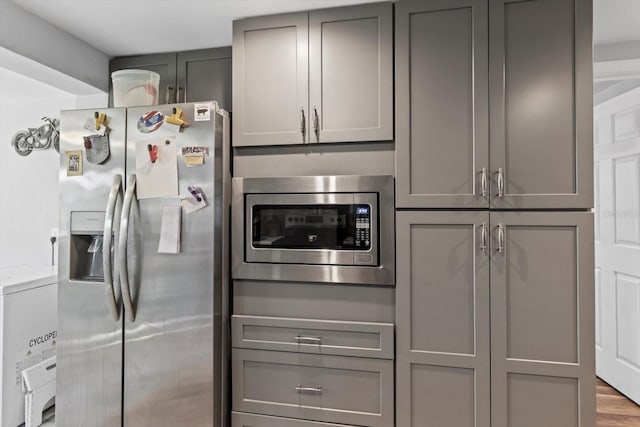 kitchen with appliances with stainless steel finishes and gray cabinetry