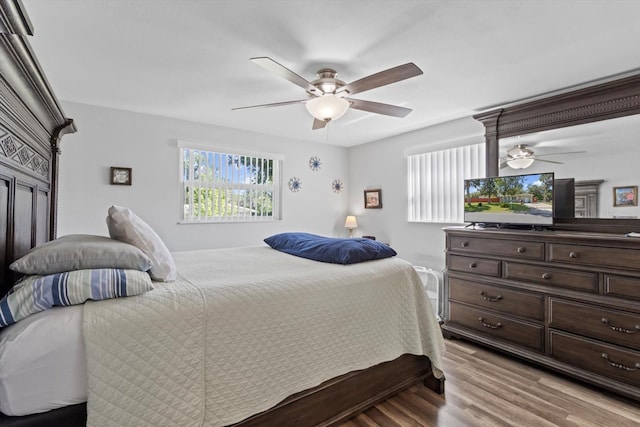 bedroom with light wood-type flooring and a ceiling fan