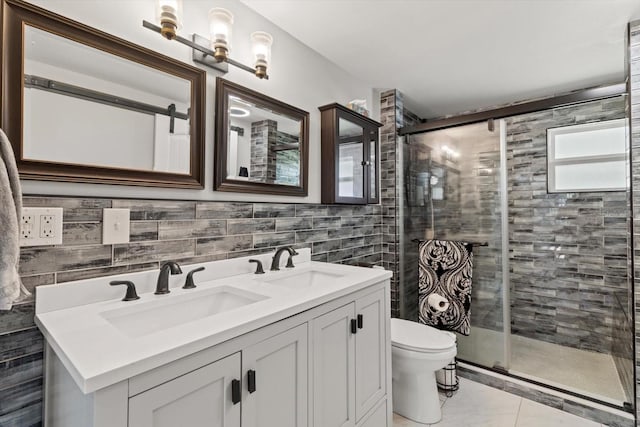 bathroom featuring tile walls, toilet, a sink, and a stall shower