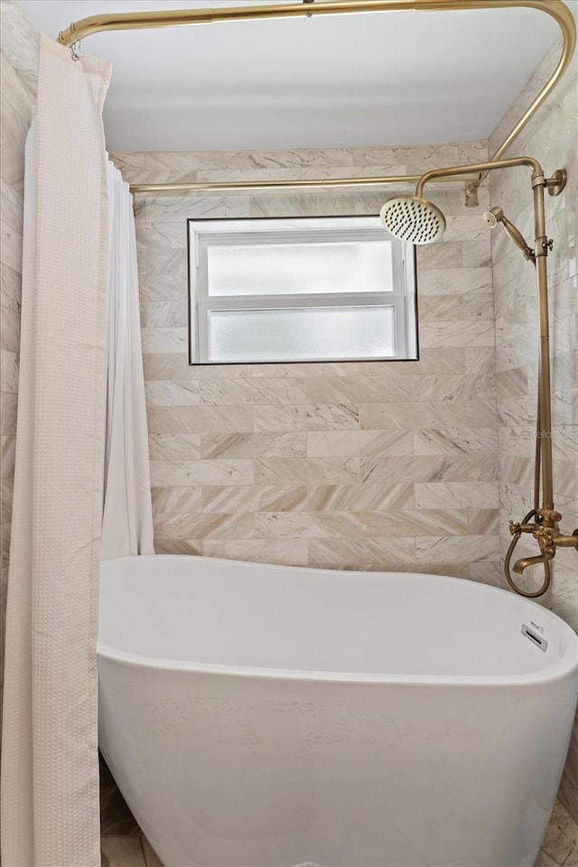 full bathroom featuring a shower with shower curtain and a soaking tub
