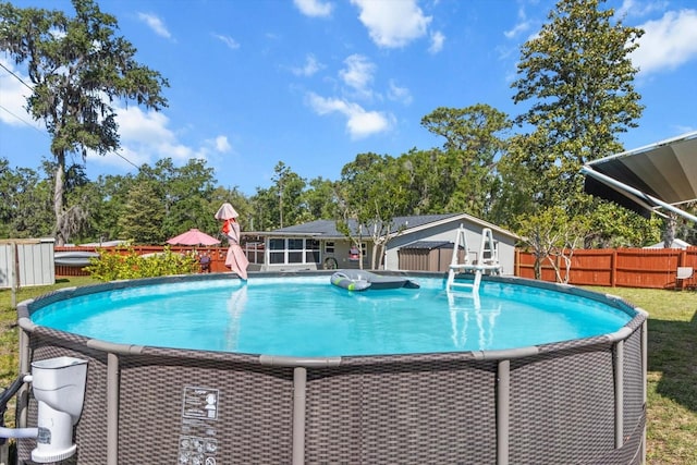 view of swimming pool with a fenced in pool and fence