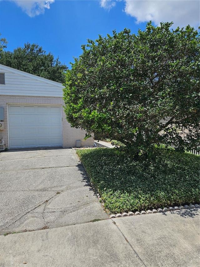 414 Danube Ave, Tampa, FL 33606 - exterior space with an attached garage, brick siding, and driveway