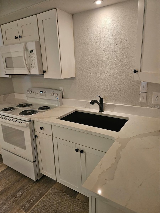 414 Danube Ave, Tampa, FL 33606 - kitchen with a sink, white appliances, light stone counters, dark wood-style floors, and white cabinets