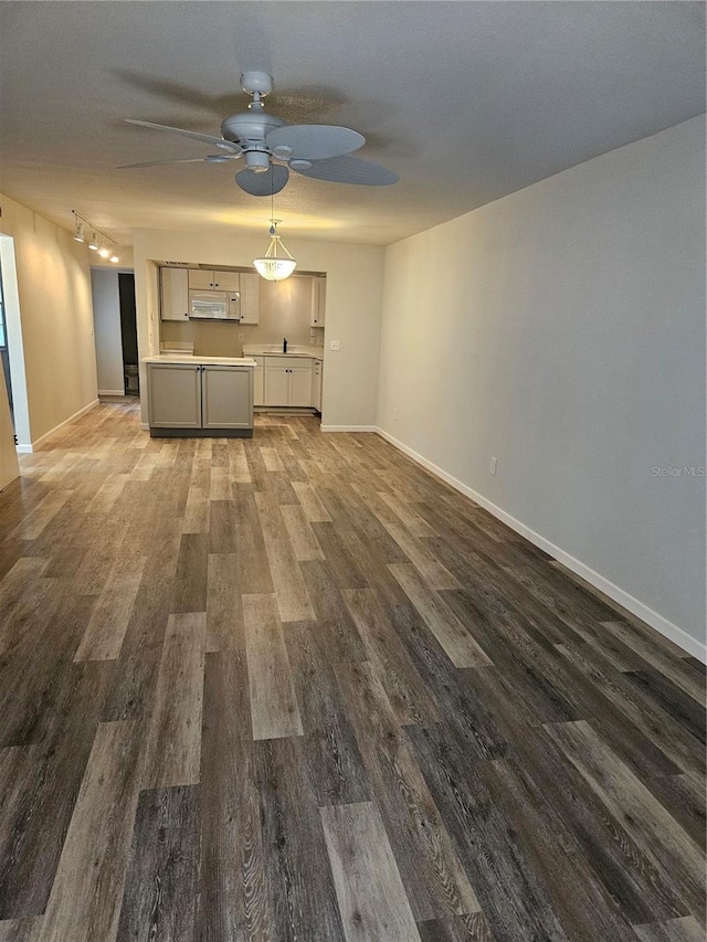 414 Danube Ave, Tampa, FL 33606 - unfurnished living room featuring a ceiling fan, baseboards, and wood finished floors