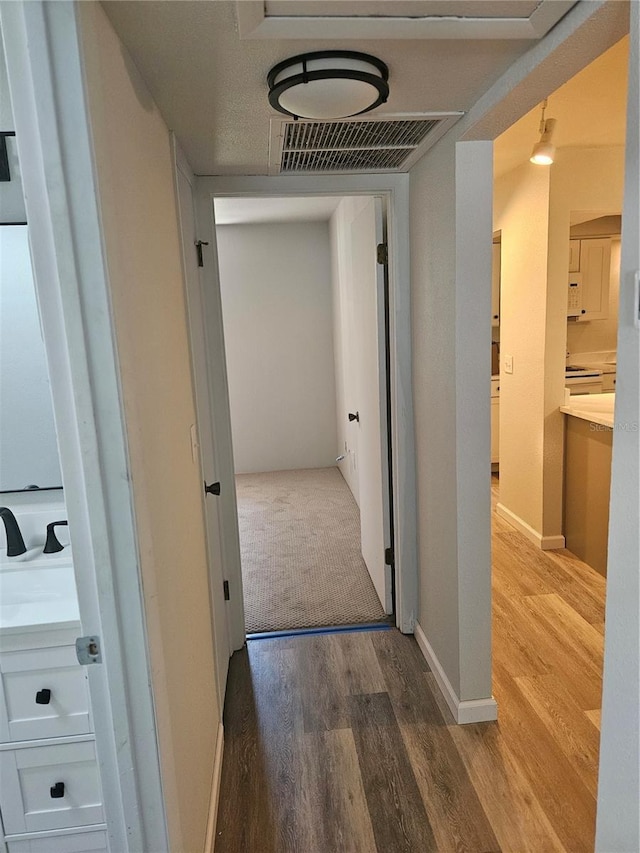 414 Danube Ave, Tampa, FL 33606 - corridor with baseboards, visible vents, and wood finished floors