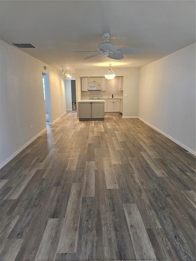 414 Danube Ave, Tampa, FL 33606 - unfurnished living room featuring ceiling fan, baseboards, visible vents, and wood finished floors