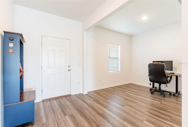 office space with light wood-style floors and baseboards