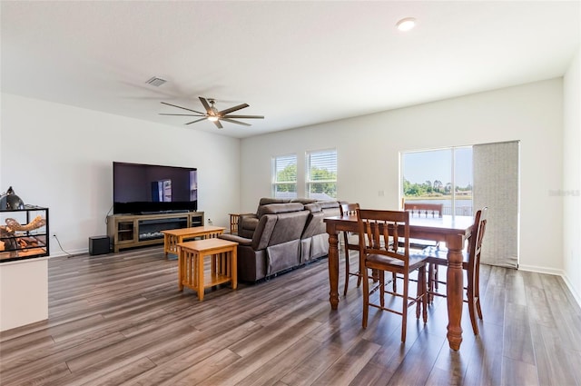 dining space featuring a ceiling fan, wood finished floors, and visible vents