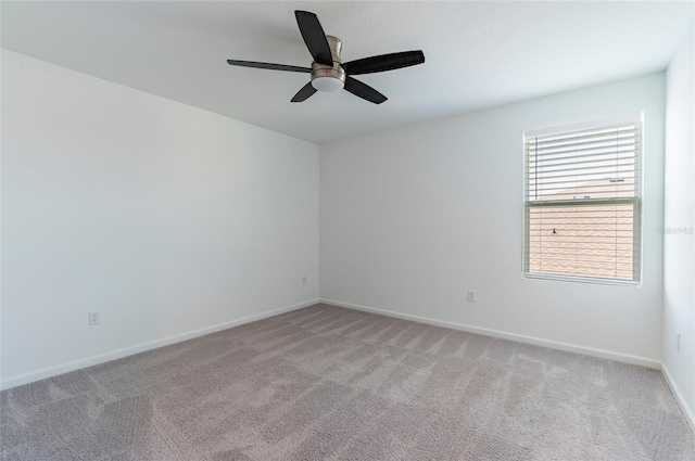 unfurnished room with ceiling fan, light carpet, and baseboards