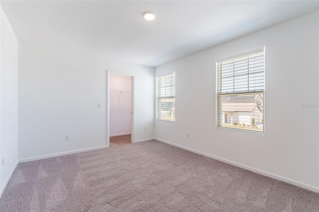 carpeted spare room with baseboards