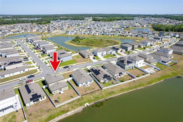 birds eye view of property with a residential view and a water view