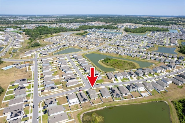 drone / aerial view with a residential view and a water view