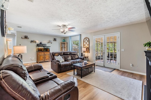 6821 Mary Lou Ln, Wesley Chapel, FL 33544 - living area with ceiling fan, french doors, visible vents, wood finished floors, and baseboards