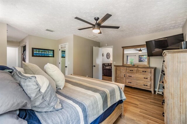 6821 Mary Lou Ln, Wesley Chapel, FL 33544 - bedroom featuring a textured ceiling, visible vents, and wood finished floors