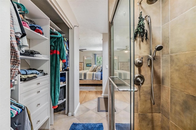 6821 Mary Lou Ln, Wesley Chapel, FL 33544 - walk in closet with ceiling fan and light tile patterned flooring