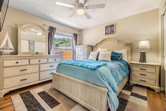 6821 Mary Lou Ln, Wesley Chapel, FL 33544 - bedroom with a textured ceiling, ceiling fan, and wood finished floors