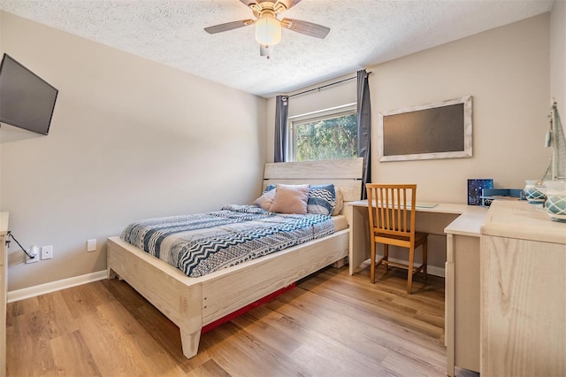 6821 Mary Lou Ln, Wesley Chapel, FL 33544 - bedroom with light wood-style floors, baseboards, ceiling fan, and a textured ceiling