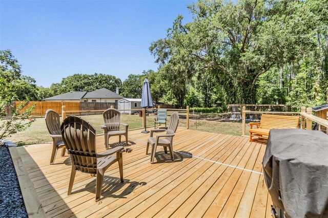 6821 Mary Lou Ln, Wesley Chapel, FL 33544 - deck with a storage shed, a lawn, an outdoor structure, and a fenced backyard