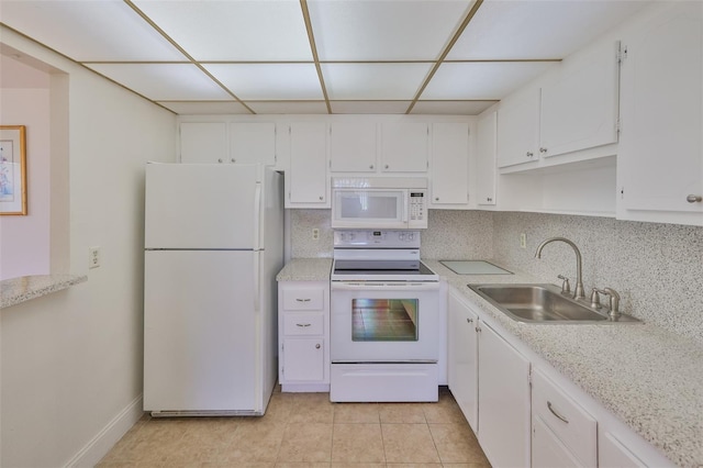 1802 Bedford Ter Unit 187, Sun City Center, FL 33573 - kitchen with white appliances, a sink, white cabinetry, and a paneled ceiling