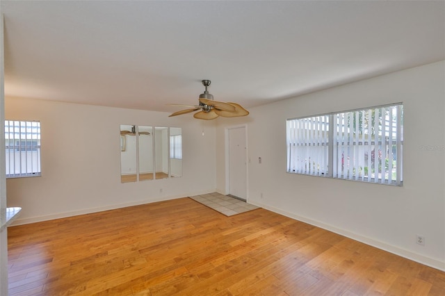1802 Bedford Ter Unit 187, Sun City Center, FL 33573 - spare room with light wood-style flooring, ceiling fan, and baseboards