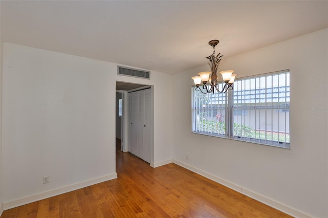 1802 Bedford Ter Unit 187, Sun City Center, FL 33573 - unfurnished dining area featuring baseboards, a chandelier, and wood finished floors
