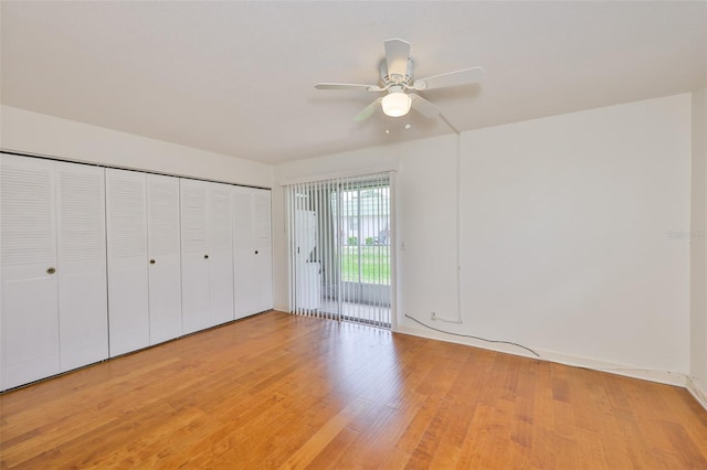 1802 Bedford Ter Unit 187, Sun City Center, FL 33573 - unfurnished bedroom featuring access to exterior, light wood-type flooring, a ceiling fan, and a closet