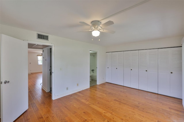 1802 Bedford Ter Unit 187, Sun City Center, FL 33573 - unfurnished bedroom with light wood-style floors, baseboards, ceiling fan, and ensuite bath