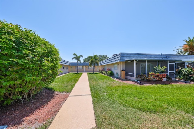 1802 Bedford Ter Unit 187, Sun City Center, FL 33573 - view of side of home featuring a yard and a sunroom