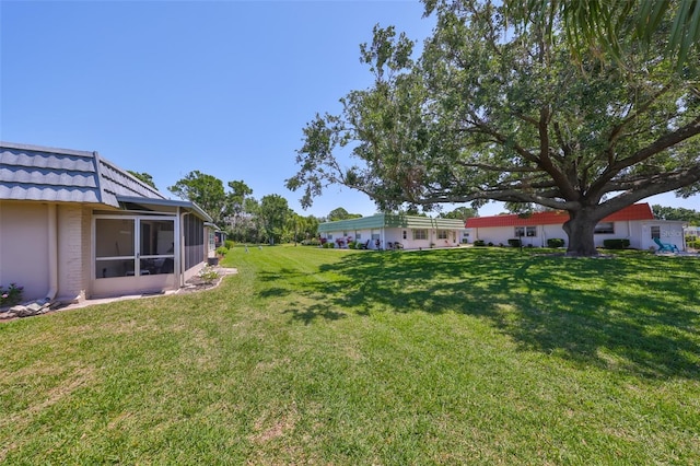 1802 Bedford Ter Unit 187, Sun City Center, FL 33573 - view of grassy yard featuring a sunroom
