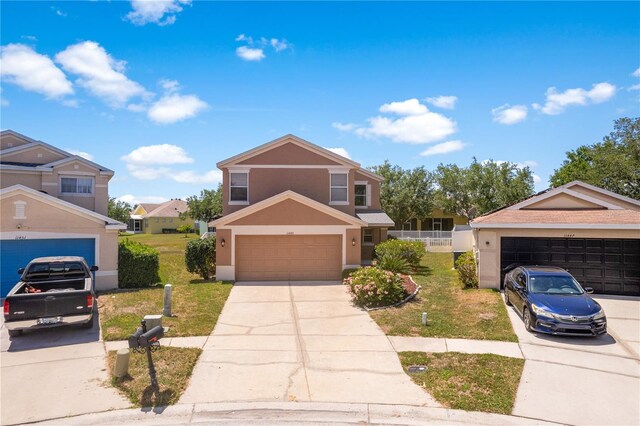 11449 Crestlake Village Dr, Riverview, FL 33569 - traditional-style house with a garage, concrete driveway, a front lawn, and stucco siding