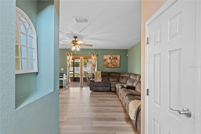 11449 Crestlake Village Dr, Riverview, FL 33569 - living room featuring wood finished floors, visible vents, and a ceiling fan