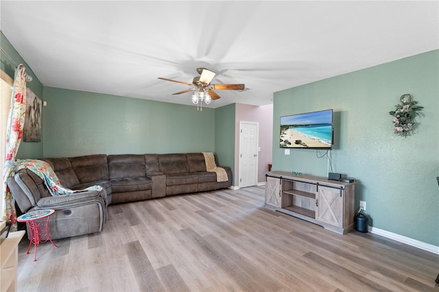 11449 Crestlake Village Dr, Riverview, FL 33569 - living area featuring wood finished floors, a textured wall, baseboards, and ceiling fan