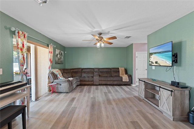 11449 Crestlake Village Dr, Riverview, FL 33569 - living room with a ceiling fan, visible vents, and light wood-type flooring