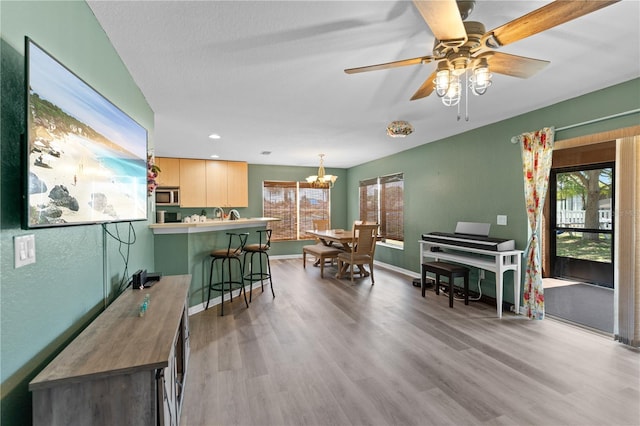 11449 Crestlake Village Dr, Riverview, FL 33569 - interior space featuring ceiling fan with notable chandelier, baseboards, wood finished floors, and recessed lighting