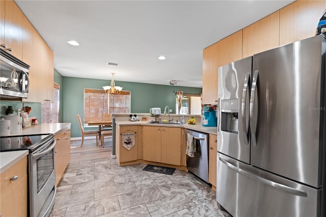 11449 Crestlake Village Dr, Riverview, FL 33569 - kitchen featuring a peninsula, a sink, a healthy amount of sunlight, a chandelier, and appliances with stainless steel finishes