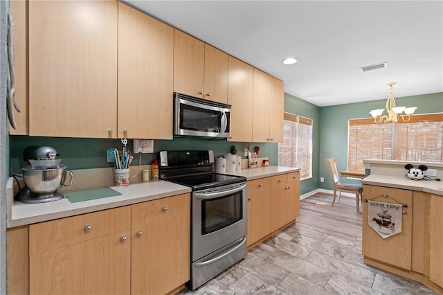 11449 Crestlake Village Dr, Riverview, FL 33569 - kitchen with light countertops, light brown cabinetry, appliances with stainless steel finishes, and an inviting chandelier