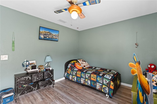 11449 Crestlake Village Dr, Riverview, FL 33569 - bedroom featuring visible vents, baseboards, wood finished floors, and ceiling fan