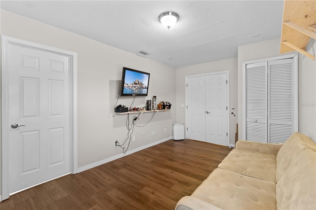 11449 Crestlake Village Dr, Riverview, FL 33569 - living area with baseboards, wood finished floors, visible vents, and a textured ceiling