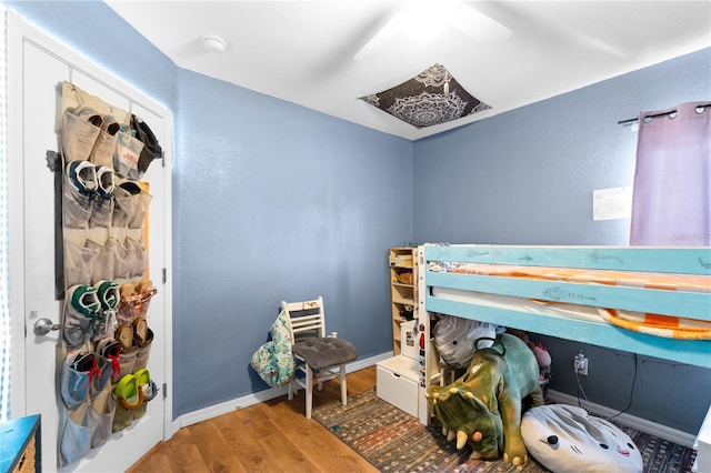 11449 Crestlake Village Dr, Riverview, FL 33569 - bedroom featuring wood finished floors, a textured wall, baseboards, and ceiling fan