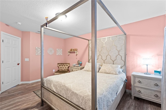 11449 Crestlake Village Dr, Riverview, FL 33569 - bedroom with baseboards, wood finished floors, and a textured ceiling