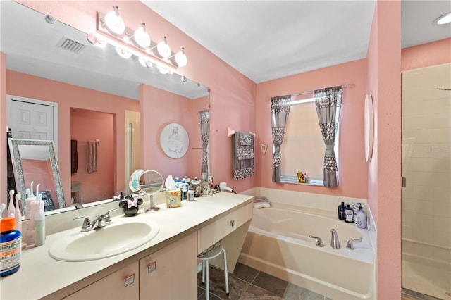11449 Crestlake Village Dr, Riverview, FL 33569 - full bath featuring tile patterned floors, visible vents, a shower stall, a garden tub, and vanity