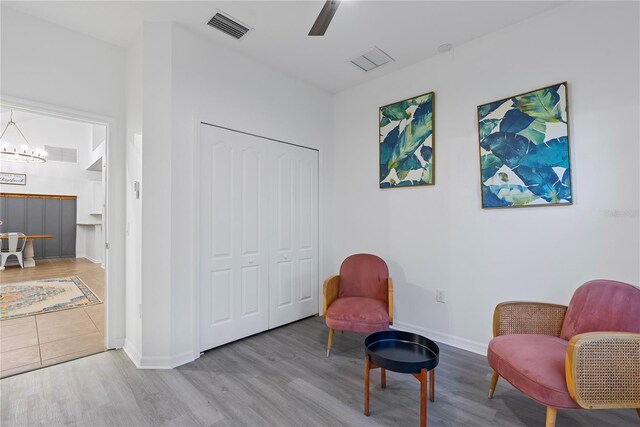 20121 Bending Creek Pl, Tampa, FL 33647 - sitting room featuring baseboards, ceiling fan with notable chandelier, wood finished floors, and visible vents