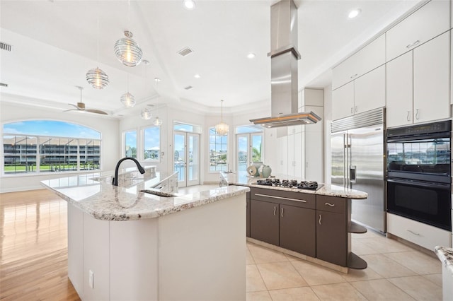 6202 Pasadena Point Blvd, Gulfport, FL 33707 - kitchen with black appliances, a kitchen island with sink, island range hood, plenty of natural light, and recessed lighting
