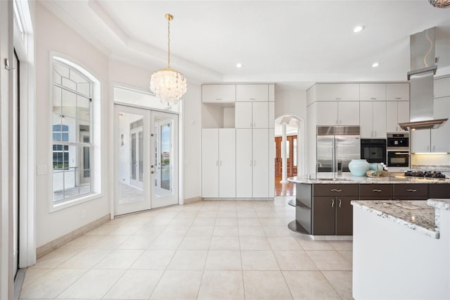 6202 Pasadena Point Blvd, Gulfport, FL 33707 - kitchen featuring stainless steel appliances, arched walkways, decorative light fixtures, a sink, and dark brown cabinetry