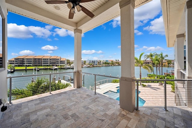 6202 Pasadena Point Blvd, Gulfport, FL 33707 - view of patio featuring a water view, a ceiling fan, and a balcony