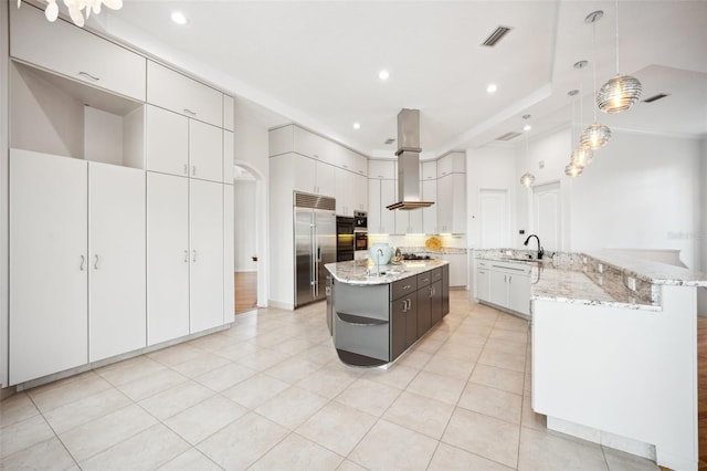 6202 Pasadena Point Blvd, Gulfport, FL 33707 - kitchen featuring appliances with stainless steel finishes, a large island, wall chimney exhaust hood, recessed lighting, and light tile patterned floors