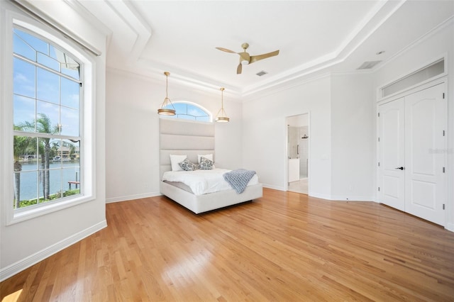 6202 Pasadena Point Blvd, Gulfport, FL 33707 - bedroom with a tray ceiling, light wood-type flooring, baseboards, and ornamental molding